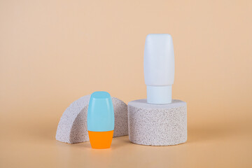 Cosmetic product in tube, bottle, lotion or serum with stylish props on cream background. 