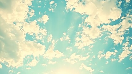 Light pastel-toned sky, filled with fluffy clouds