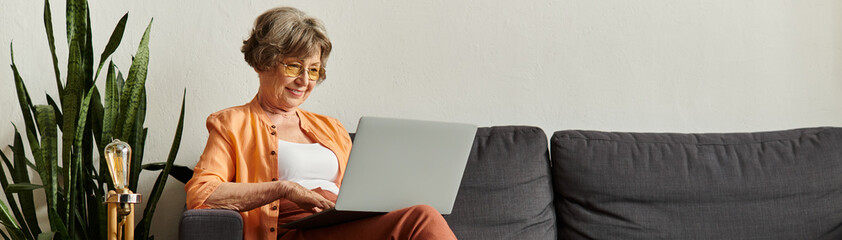 Senior woman enjoys cozy afternoon while browsing online at home