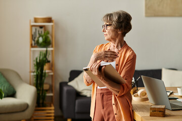 Comfortable senior woman reflects on life while enjoying a cozy day at home