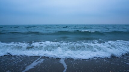 Fototapeta premium Coastal scene at dusk; waves on a beach