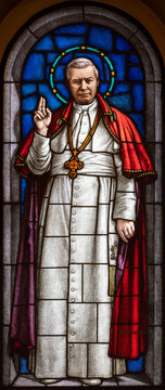 Milan - The St. pope Pius X on the stained glass in the church Chiesa di San Agostino by Eugenio Cisterna from beginn of 20. cent.
