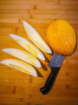 View of a cutting board with a sliced Canarian melon