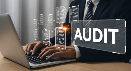 A person types on a laptop with audit text and checklist icons floating in the foreground view online