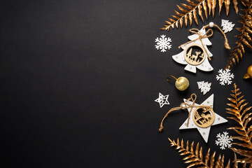 Christmas decorations with wooden tree and star ornaments, snowflakes, and golden foliage on a...