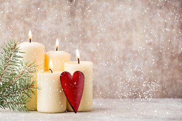 Festive scene with lit candles, red heart, and falling snow, perfect for Christmas, Valentine's...