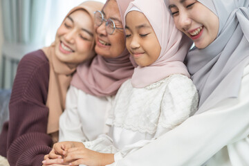Four generations of muslim woman in hijab enjoying family time showing love, joy and happiness,...