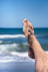 Enjoying a sunny summer day at the beach with sand between my toes and waves crashing nearby