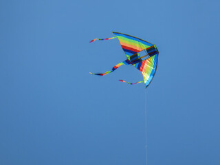 Colorful kite floating on the blue sky