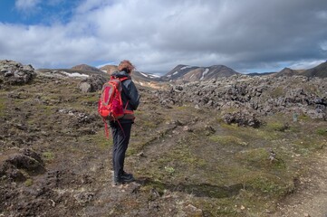 Senior woman hiking in Landmannalaugar Rainbow mountains, Iceland