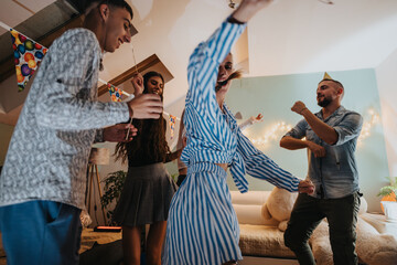 Young family celebrating a birthday at home, enjoying music and laughter in a cozy decorated...