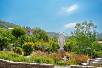 Catholic Church courtyard with Statue of Virgin Mary in Cres town, Croatia