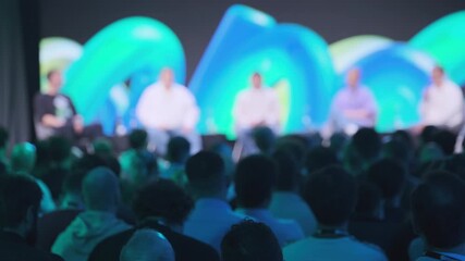 Colorful seminar stage with blurred focused audience at business panel discussion during event