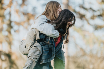 Two female teenagers having fun together in a natural setting. Playful and lively emotions captured...
