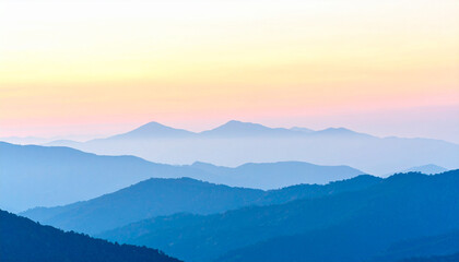 Fototapeta premium Mountain Silhouette at Sunset: A serene vista of majestic mountain ranges fading into the soft hues of a tranquil sunset, evoking a sense of peace and natural wonder.