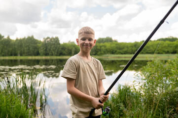 Blond boy fishing on colorful lake shore, enjoying summer day in nature with fishing rod