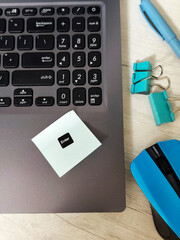 Workplace with laptop, blue wireless mouse, envelopes, notebook, office desk, sticky notes on a...
