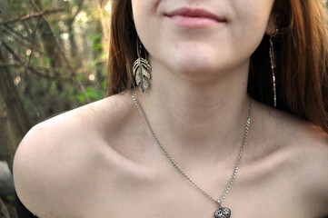 shoulder, lip, collarbone, neck of a European girl, decoration, earrings, necklace, leather, skin...