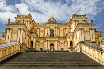 Basilica of the Visitation in the town of Wambierzyce. A Baroque basilica in Wambierzyce, Poland. A beautiful church in gold, yellow, and orange.