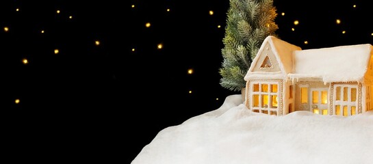 Christmas cards. Gingerbread house, night sky, copy space. Lights, coziness. Black background. Snow covered doors, snowy roof, stars, snowflakes, winter. Food, baking concept
