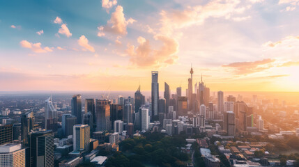 Obraz premium Golden hour cityscape: Skyscrapers rise against a vibrant sunset sky, urban panorama in warm light.