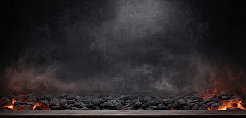 Charcoal embers glowing with smoke in dark background