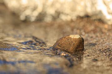 sea wave on the shore and a little rock in the sand for grafik and design purposes