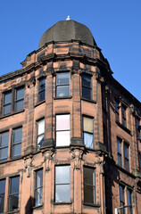 Old 19th Century Office Building with Octagonal Corner Cupola seen against Blue Sky