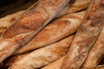 Freshly baked,  crisp and crunchy baguette loaves on sale in a bakery.