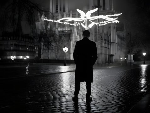 Fototapeta Man in coat standing on cobblestone street at night black and white paris france scene