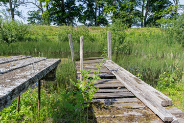 Fototapeta premium Title: Rustic Dock and Bench by Pond