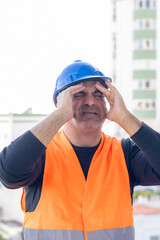 Tired and exhausted mechanical technician or building contractor. Bad news triggering headache