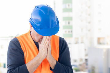 Tired and exhausted mechanical technician or building contractor. Bad news triggering headache