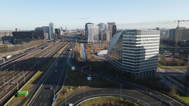 Aerial view of the Deloitte building and highways, a modern landscape blending architecture with transportation arteries, Amsterdam, North Holland, Netherlands.