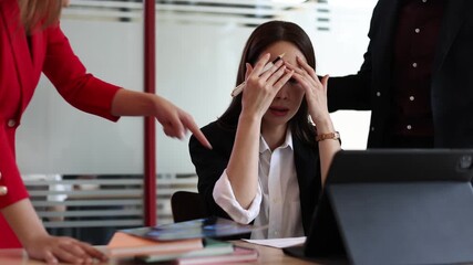 Businessman arguing during a meeting in an office. Colleagues are discussing a project, but they are having a disagreement and the woman is stressed, covering his face with his hands.