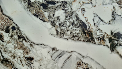 natural marble texture featuring intricate veins in neutral tones of white, beige, brown, and blac