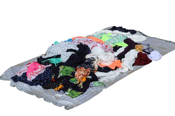 Pile of colorful second hand clothes on transparent background