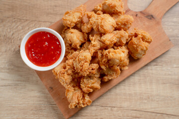 Crispy Popcorn Chicken with sauce and mayonnaise on a wooden board. Perfect for recipes, articles...