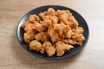 Crispy Popcorn Chicken with sauce and mayonnaise on a black plate. Perfect for recipes, articles or...