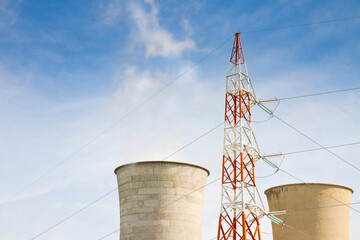 Geothermal power plant in tuscany hills with electricity pylon (Italy)