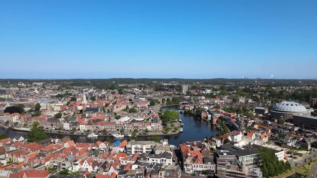 Aerial view of the Haarlem cityscape, where terracotta rooftops meet the deep blue waters, creating a stunning contrast, Haarlem, North Holland, Netherlands.