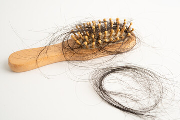 Hair loss fall with comb brush isolated on white background.