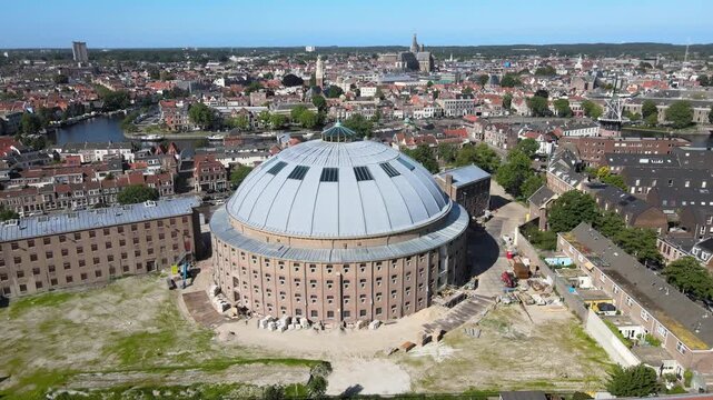 Aerial view of the historic Grote Kerk church towering over the old town, and boats docked along the water, Haarlem, North Holland, Netherlands.