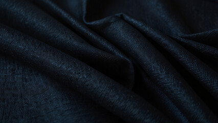 Fototapeta premium Textured dark blue fabric with subtle shimmer and folds