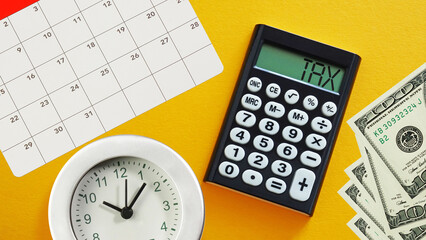Tax Time Concept is shown with calculator and calendar. Time for taxes or tax season