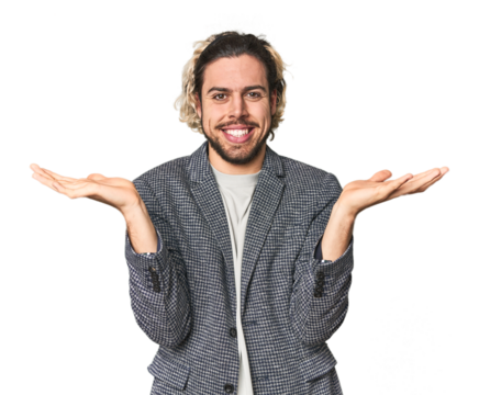 Young businessman in casual blazer makes scale with arms, feels happy and confident.