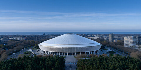 Fototapeta premium Futuristic Johan Cruyff Arena Aerial View Modern Stadium Design Drone Shot of Amsterdam Arena Architectural Marvel Innovative Sports Venue Top Down View of Football Stadium 