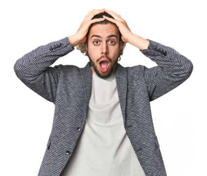 Young businessman in casual blazer screaming, very excited, passionate, satisfied with something.