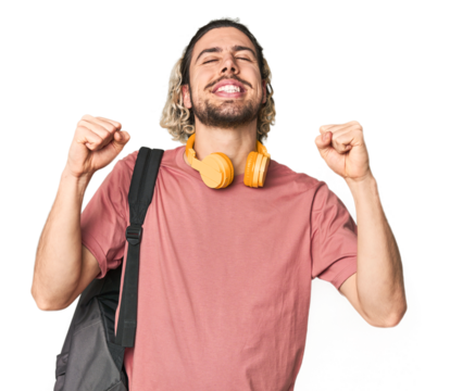 Young student with backpack and headphones celebrating a victory, passion and enthusiasm, happy expression.