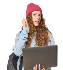 Redhead young woman student with laptop trying to listening a gossip.